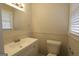 Bright bathroom featuring a white vanity, toilet, and a large mirror at 2509 Appomattox Dr, Decatur, GA 30034