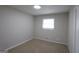 Serene bedroom featuring neutral tones, plush carpeting, and a window for natural light at 2509 Appomattox Dr, Decatur, GA 30034