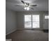 Bright living room featuring neutral paint, plush carpeting, and natural light from large window at 2509 Appomattox Dr, Decatur, GA 30034