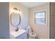 Bathroom vanity with brushed bronze fixtures, with a shower and window providing natural light at 2282 Tiffany Ct, Jonesboro, GA 30236