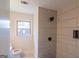 Bathroom showcasing a tiled walk-in shower with black fixtures and a window for natural light at 2282 Tiffany Ct, Jonesboro, GA 30236