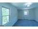 A sunlit bedroom showcases windows allowing natural light and neutral carpet at 2282 Tiffany Ct, Jonesboro, GA 30236