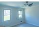 Bedroom featuring two windows, neutral paint, modern ceiling fan, and new flooring at 2282 Tiffany Ct, Jonesboro, GA 30236