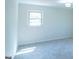 Well lit bedroom features neutral paint, carpet, and a window at 2282 Tiffany Ct, Jonesboro, GA 30236