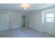 Bedroom features neutral paint, carpet, window, and closet access at 2282 Tiffany Ct, Jonesboro, GA 30236