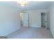 Bright bedroom featuring neutral walls, carpet, modern lighting, and closet space at 2282 Tiffany Ct, Jonesboro, GA 30236