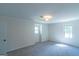 Spacious bedroom features two windows, neutral paint, and carpet at 2282 Tiffany Ct, Jonesboro, GA 30236