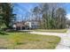 Traditional two-story house with attached garage, circular driveway and mature trees creating a private setting at 2282 Tiffany Ct, Jonesboro, GA 30236