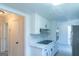 Bright kitchen features white cabinets, stainless steel appliances, and modern lighting at 2282 Tiffany Ct, Jonesboro, GA 30236