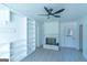 Living room featuring a fireplace, built-in shelving, new floors, and great lighting at 2282 Tiffany Ct, Jonesboro, GA 30236