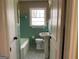 Bathroom with pedestal sink, vintage tile, and mosaic tile flooring at 1271 Sanders Dr, Lake City, GA 30260