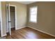 Bedroom features hardwood floors, neutral walls, and a closet to maximize storage at 1271 Sanders Dr, Lake City, GA 30260