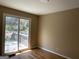 Bright bedroom features hardwood floors and sliding glass doors to a wooden deck at 1271 Sanders Dr, Lake City, GA 30260