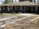 Charming single-story home with a covered porch, classic architectural details, and a spacious front yard at 1271 Sanders Dr, Lake City, GA 30260