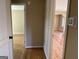 Hallway featuring hardwood floors and doorways that lead to other rooms in the home at 1271 Sanders Dr, Lake City, GA 30260