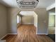 Spacious living area with gleaming hardwood floors and an open archway to another room at 1271 Sanders Dr, Lake City, GA 30260
