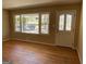 Bright living room with hardwood floors and a view of the neighborhood through decorative windows at 1271 Sanders Dr, Lake City, GA 30260