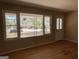 Sunlit living room with decorative windows, hardwood floors, and a view of the neighborhood at 1271 Sanders Dr, Lake City, GA 30260