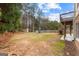 Sprawling backyard with a wooden playset, shed, and deck overlooking the grounds at 1301 Blue Sky Ct, Peachtree City, GA 30269