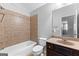 Bathroom featuring a tub-shower combo with tiled walls and a vanity at 1301 Blue Sky Ct, Peachtree City, GA 30269