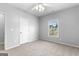 Neutral bedroom features a bright window, neutral walls, and carpet at 1301 Blue Sky Ct, Peachtree City, GA 30269
