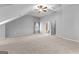 Large bedroom with neutral colors, ceiling fan and view of the bathroom at 1301 Blue Sky Ct, Peachtree City, GA 30269