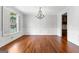 Elegant dining room with hardwood floors, chandelier, and large window at 1301 Blue Sky Ct, Peachtree City, GA 30269