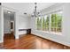 Dining room featuring hardwood floors, a chandelier, built-in desk, and large windows offering natural light at 1301 Blue Sky Ct, Peachtree City, GA 30269
