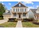 Inviting front exterior featuring a classic porch with columns and professionally landscaped front yard at 1301 Blue Sky Ct, Peachtree City, GA 30269