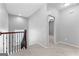 Upstairs hallway featuring neutral walls and carpeting, a window for natural light, and open doorway to other rooms at 1301 Blue Sky Ct, Peachtree City, GA 30269