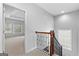 Hallway showcases dark wood banister and carpeted stairs at 1301 Blue Sky Ct, Peachtree City, GA 30269