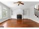 Cozy living room featuring a fireplace, built-ins, and hardwood floors at 1301 Blue Sky Ct, Peachtree City, GA 30269