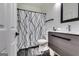 Well-lit bathroom with a patterned shower curtain, modern vanity, and black fixtures, offering a clean design at 4450 Sterling Forest Dr, Decatur, GA 30034