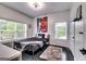 Bright bedroom with a modern light fixture, large windows, and sleek platform bed at 4450 Sterling Forest Dr, Decatur, GA 30034