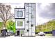 Striking modern home boasting a geometric design with a sleek, white exterior and black accents at 4450 Sterling Forest Dr, Decatur, GA 30034