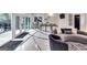 Open-concept living area featuring a unique curved sofa, large windows, and access to the outdoor space at 4450 Sterling Forest Dr, Decatur, GA 30034