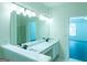 Bathroom featuring a double sink vanity with marble countertop, a large mirror, and a shower at 8030 Snapwell Dr, Fairburn, GA 30213