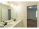 Bathroom featuring double sinks, marble countertops, modern lighting and fixtures at 8030 Snapwell Dr, Fairburn, GA 30213