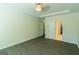 Bright bedroom featuring a ceiling fan, neutral walls, and modern gray flooring at 8030 Snapwell Dr, Fairburn, GA 30213