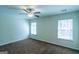 A bright bedroom features neutral walls, carpeted floors, and two windows at 8030 Snapwell Dr, Fairburn, GA 30213