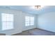 This bedroom has two windows letting in natural light, with neutral paint and carpet flooring at 8030 Snapwell Dr, Fairburn, GA 30213