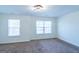 Bedroom with two windows providing natural light and comfortable carpeted floors at 8030 Snapwell Dr, Fairburn, GA 30213