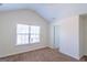 A bright bedroom features neutral walls, carpeted floors, a window, and a white door at 8030 Snapwell Dr, Fairburn, GA 30213
