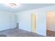 Bright bedroom with neutral walls, carpet flooring, closet and multiple doorways at 8030 Snapwell Dr, Fairburn, GA 30213