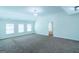 A bonus room with neutral walls, carpeted floors and three windows at 8030 Snapwell Dr, Fairburn, GA 30213