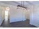 Bright dining room featuring modern light fixture, wainscotting and elegant gray flooring at 8030 Snapwell Dr, Fairburn, GA 30213