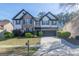 Charming two-story home featuring a stone facade, dark shutters, and a well-manicured front lawn at 8030 Snapwell Dr, Fairburn, GA 30213