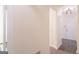 Bright hallway featuring gray flooring, white trim, and views into adjacent rooms at 8030 Snapwell Dr, Fairburn, GA 30213