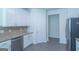 Modern kitchen featuring white cabinets, stainless steel appliances, and granite countertops at 8030 Snapwell Dr, Fairburn, GA 30213