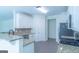 Open-concept kitchen with granite countertops, stainless steel appliances, and white cabinetry at 8030 Snapwell Dr, Fairburn, GA 30213